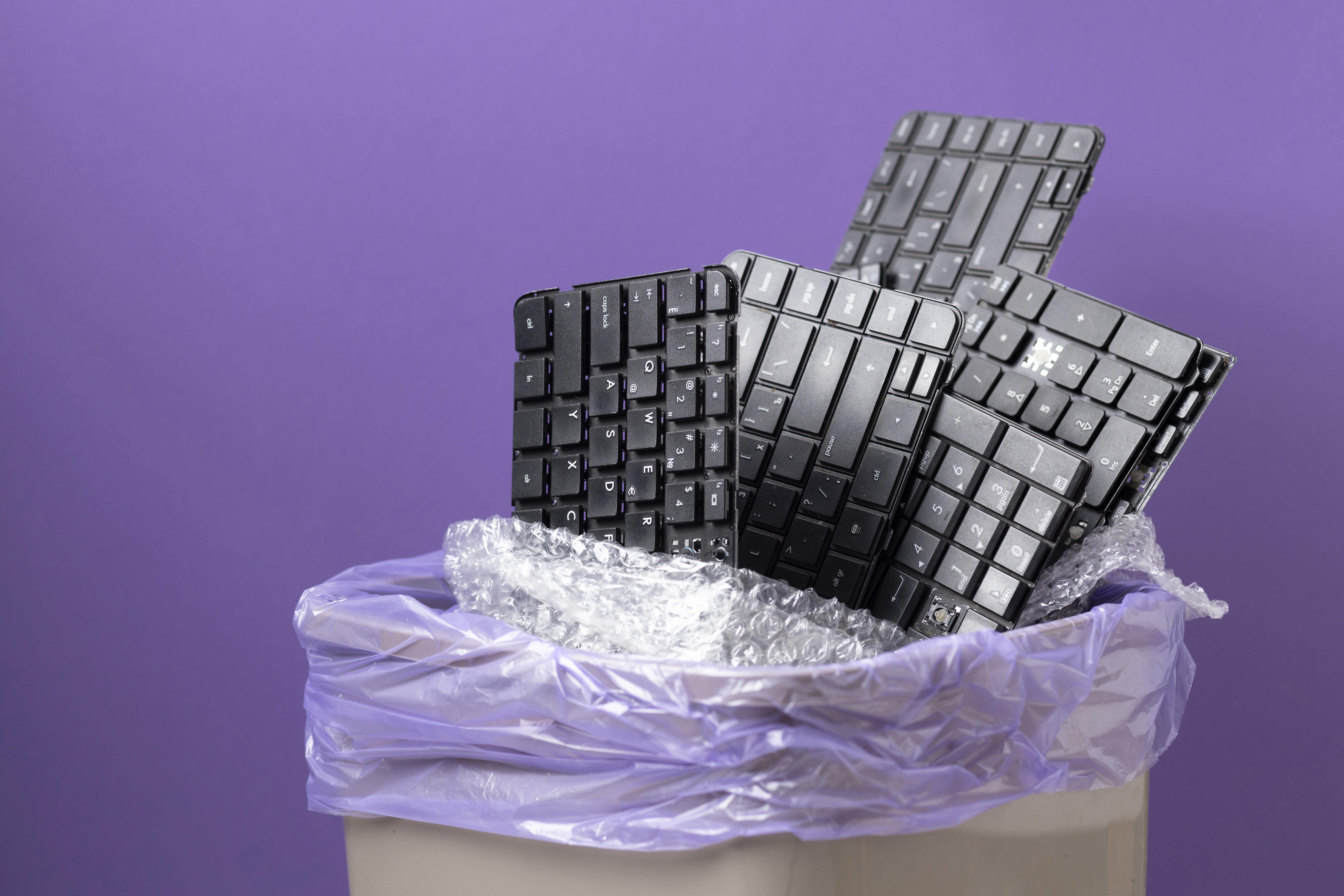 pile of old unsused keyboards waste